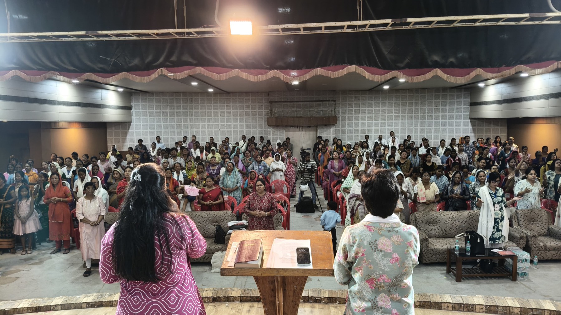 The Encourage Conference hall in Guwahati, women standing in worship