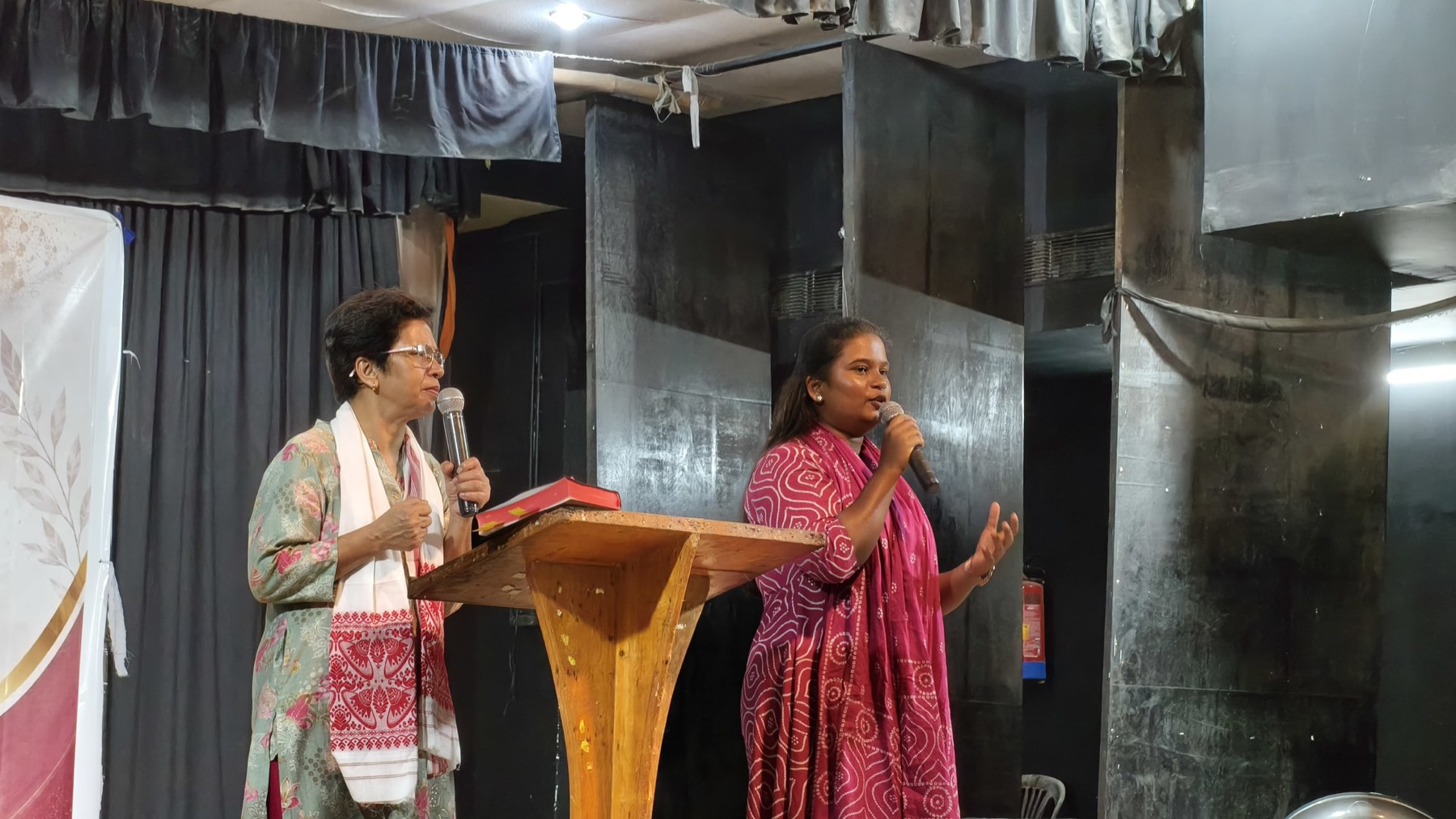 Two First Witness leaders speaking at the pulpit